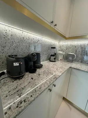 a kitchen counter with a camera on top of it at Fifth Element Pool Villa By Ere in Laguna Phuket