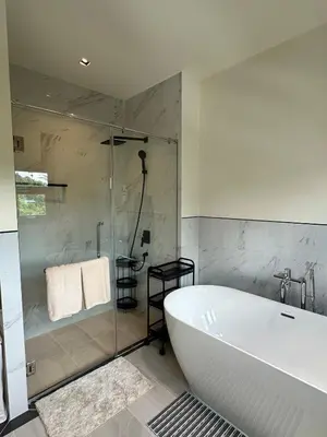 a bathroom with a bath tub and a shower at Fifth Element Pool Villa By Ere in Laguna Phuket