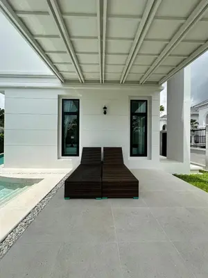 a bed in the middle of a house at Fifth Element Pool Villa By Ere in Laguna Phuket