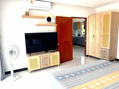 a living room with a flat screen tv sitting on a stand at Relife apartments Большая квартира с панорамным видом на горы на Най Харне in Phuket Town