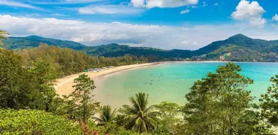 a view of a beach with palm trees and the ocean at The Escape Kamala in Kamala Beach