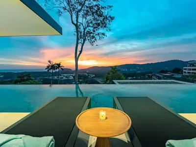 a table on a patio with a view of the ocean at NEW Luxury 4BR Villa in Layan - Villa Zuma in Layan Beach