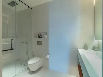 a white bathroom with a toilet and a shower at NEW Luxury 4BR Villa in Layan - Villa Zuma in Layan Beach