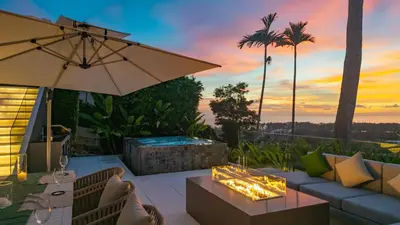 a patio with a couch and an umbrella and a fire pit at NEW Luxury 4BR Villa in Layan - Villa Zuma in Layan Beach