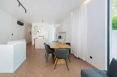 a kitchen and dining room with a wooden table and chairs at Villa Heaven in Kata Beach