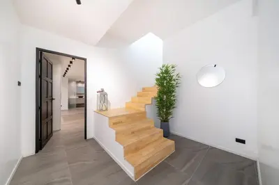 a staircase in a house with a potted plant at Villa Heaven in Kata Beach