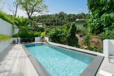 a swimming pool in the backyard of a house at Villa Heaven in Kata Beach