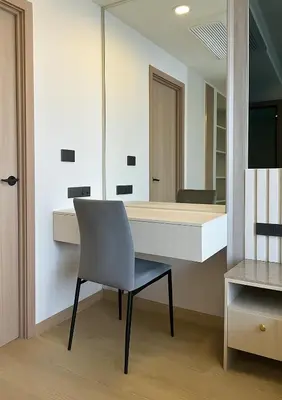 a chair sitting in front of a desk with a mirror at The Ozone Condominium 2 bedroom by Search Estate in Phuket Town
