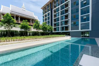 a swimming pool in front of a building at The Ozone Condominium 2 bedroom by Search Estate in Phuket Town