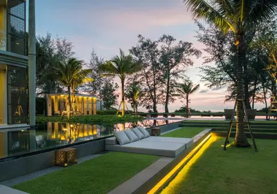 a living area with a couch in front of a building at Baan Mai Khao Beach Residence in Mai Khao Beach