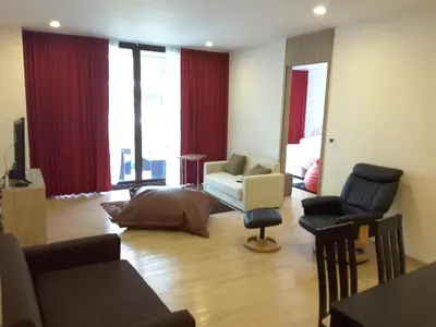 a living room with a couch and a chair at Baan Mai Khao Beach Residence in Mai Khao Beach