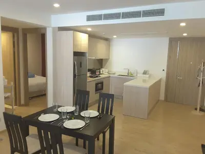 a kitchen and dining room with a table and chairs at Baan Mai Khao Beach Residence in Mai Khao Beach