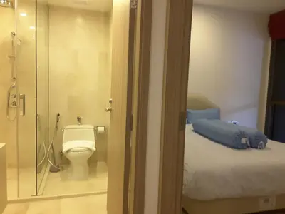 a bathroom with a bed and a toilet and a shower at Baan Mai Khao Beach Residence in Mai Khao Beach