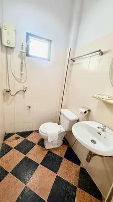 a bathroom with a toilet and a sink at Cozy Bay Rawai in Phuket Town
