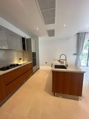 a large kitchen with a sink and a counter at Anchan Tropicana By Ere in Ban Phru Champa
