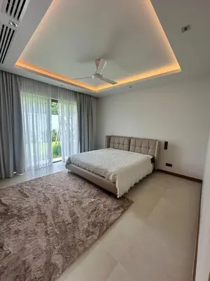 a bedroom with a bed and a ceiling at Anchan Tropicana By Ere in Ban Phru Champa