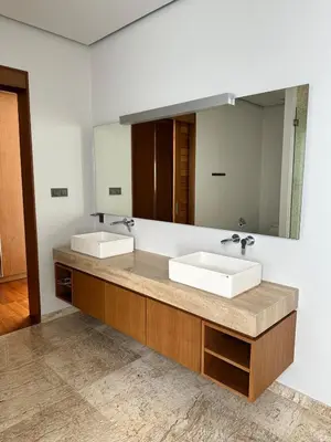 a bathroom with two sinks and a large mirror at Anchan Tropicana By Ere in Ban Phru Champa