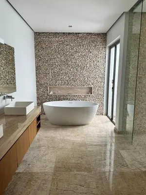 a bathroom with a large tub and a sink at Anchan Tropicana By Ere in Ban Phru Champa
