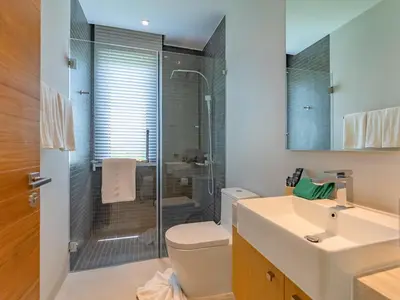a bathroom with a shower and a toilet and a sink at NEW Cozy 3BR Luxury Pool Villa - Villa Nova in Ban Pak Lak