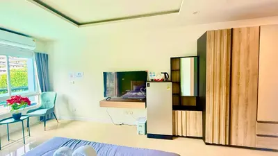 a room with a refrigerator and a table and a desk at Abdullah Residence in Patong Beach