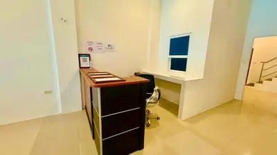 a office with a desk and a window in a room at Abdullah Residence in Patong Beach