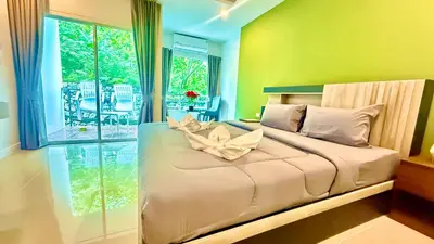 a bedroom with a bed with a flower on it at Abdullah Residence in Patong Beach