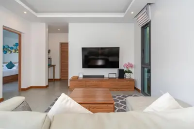 a living room with a couch and a flat screen tv at Nicky Luxury Private Pool Villa in BangTao Laguna in Laguna Phuket