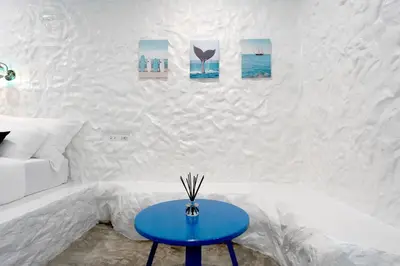 a blue table in a living room with a couch at Sweett Lemon Home in Patong Beach