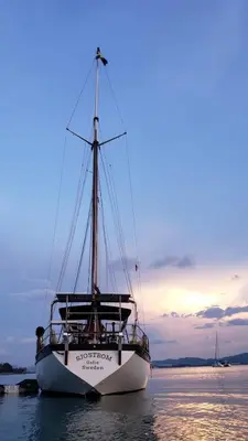 a boat sitting in the water at sunset at Sjostrom in Ban Ko En