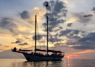 a sail boat in the water with a sunset at Sjostrom in Ban Ko En