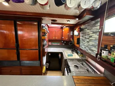 an rv kitchen with wooden cabinets and a sink at Sjostrom in Ban Ko En