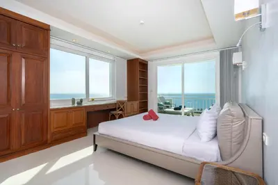 a bedroom with a bed with a view of the ocean at Waterfront 16D seaview 2 BR apartment - 5 min walk to Karon beach in Karon Beach