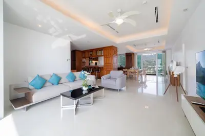 a living room with a couch and a table at Waterfront 16D seaview 2 BR apartment - 5 min walk to Karon beach in Karon Beach
