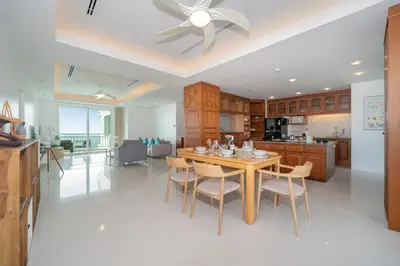 a kitchen and dining room with a table and chairs at Waterfront 16D seaview 2 BR apartment - 5 min walk to Karon beach in Karon Beach