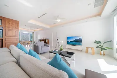 a living room with a couch and a table at Waterfront 16D seaview 2 BR apartment - 5 min walk to Karon beach in Karon Beach