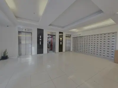 a large hallway with a white tile floor and a wall at WIVA by Woytuk in Patong Beach