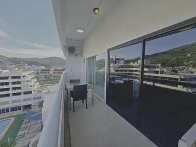 a balcony with a table and a view of the water at WIVA by Woytuk in Patong Beach