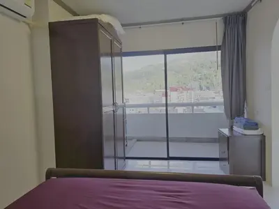 a bedroom with a bed and a large window at WIVA by Woytuk in Patong Beach