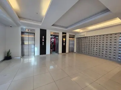 an empty lobby with doors and a tile floor at WIVA by Woytuk in Patong Beach