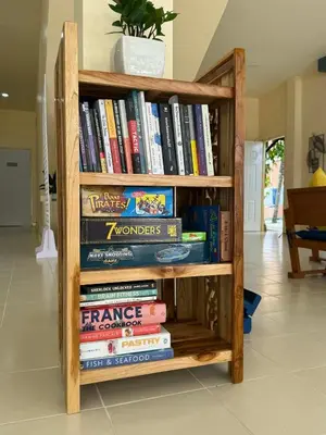 a book shelf filled with lots of books at Kata Kata Stay in Kata Beach