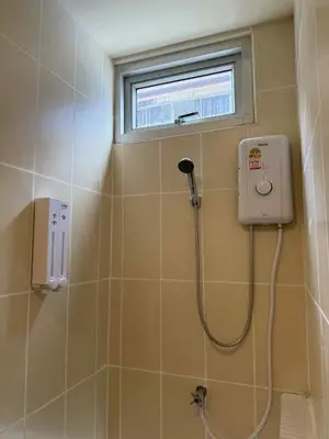 a shower in a bathroom with a window at Kata Kata Stay in Kata Beach