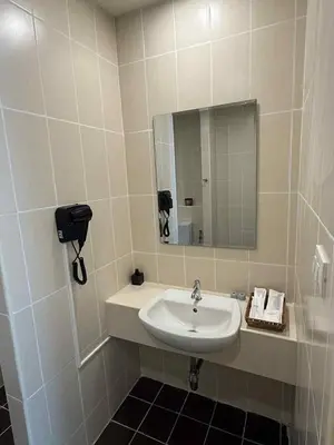 a bathroom with a sink and a mirror at Kata Kata Stay in Kata Beach