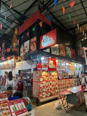 a food market with people standing in front of it at Kata Kata Stay in Kata Beach