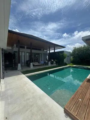 a swimming pool in front of a house at Luxury Botanica Foresta 4 bed in Ban Phru Champa