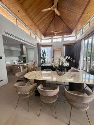 a dining room with a large table and chairs at Luxury Botanica Foresta 4 bed in Ban Phru Champa