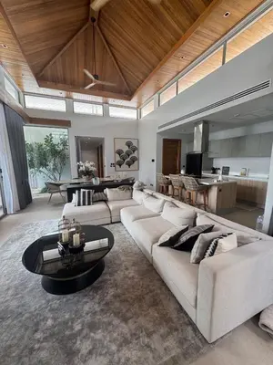 a living room with a large couch and a table at Luxury Botanica Foresta 4 bed in Ban Phru Champa