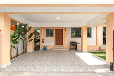a front porch of a home with a wooden door at Orchid Pool Villa Rawai in Rawai Beach