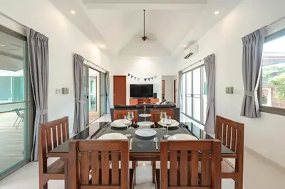 a dining room with a table and chairs at Orchid Pool Villa Rawai in Rawai Beach