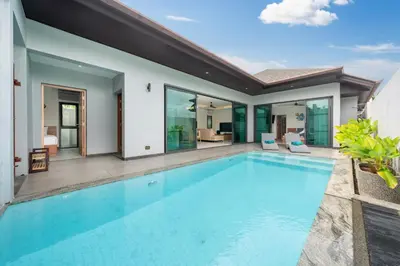 a swimming pool in the backyard of a house at Luxury 3BR Pool Villa Relaxation in BangTao Laguna in Laguna Phuket