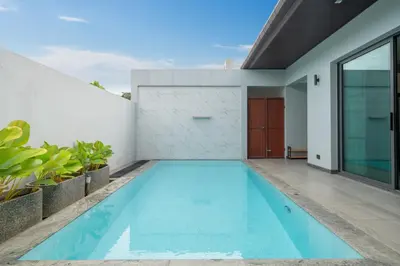 an empty swimming pool in the backyard of a house at Luxury 3BR Pool Villa Relaxation in BangTao Laguna in Laguna Phuket